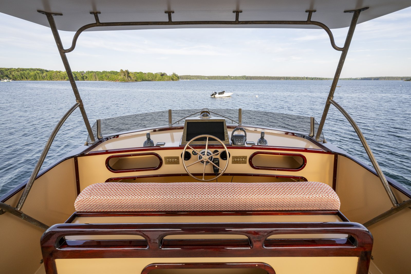 Upper helm station, with a bronze wheel and varnished mahogany finish. Photo: Cory Silken