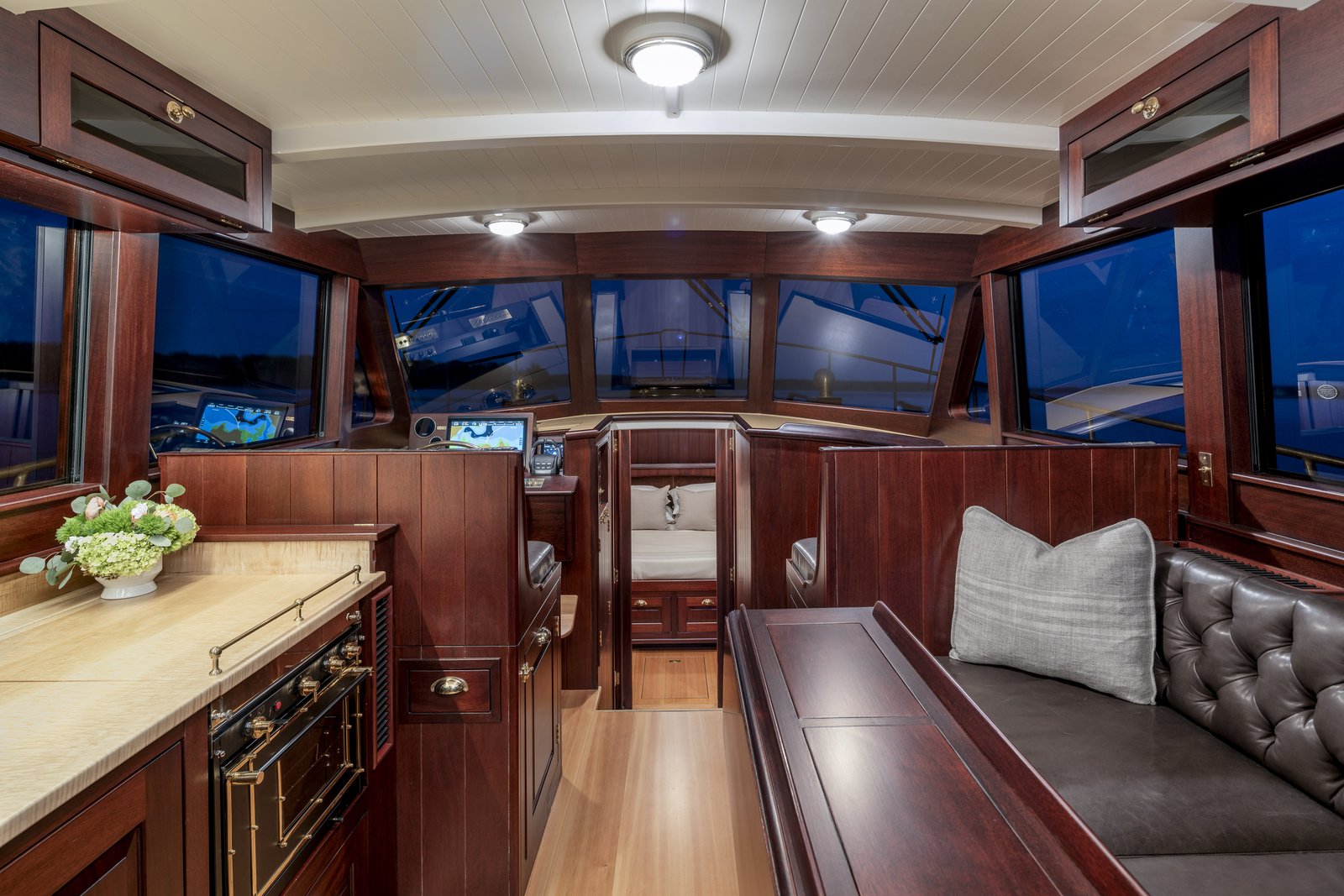 Salon interior, with mahogany joinery and large glazed areas. Photo: Cory Silken