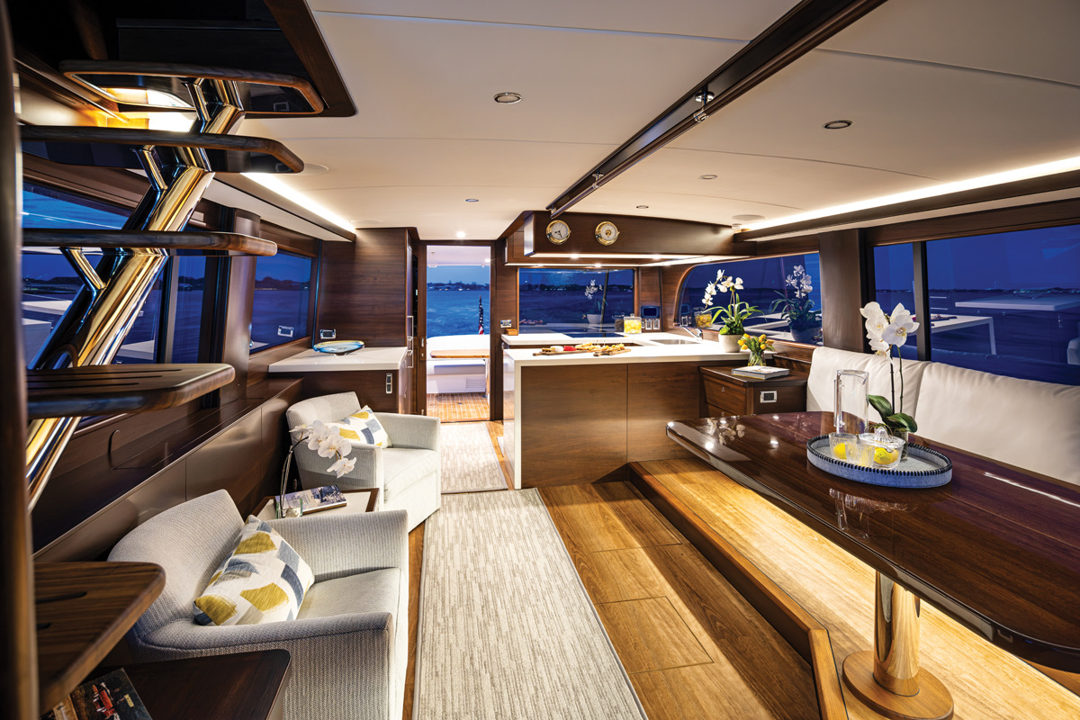 The GB65 salon, with the space integrated into the galley beyond and large side windows. Photo: Courtesy Grand Banks